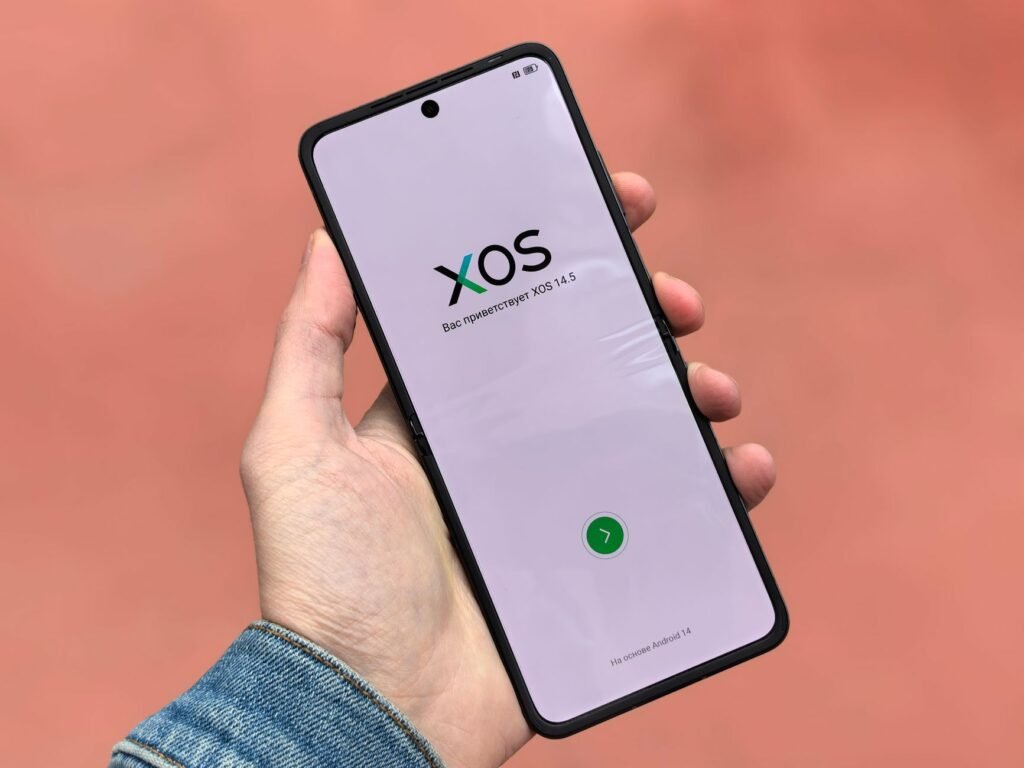 Compact foldable flip phone held in a hand