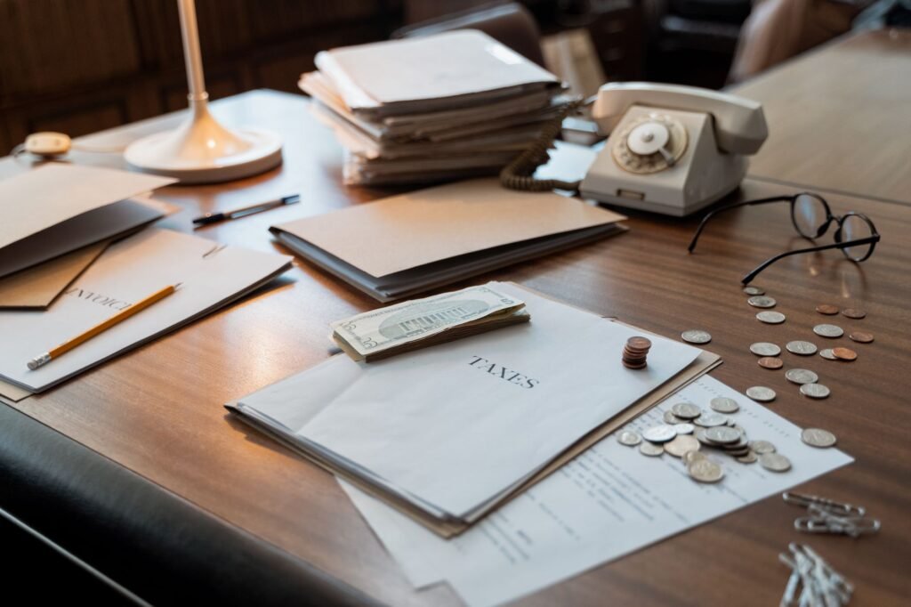Tax documents and coins on a desk representing US states with no income tax