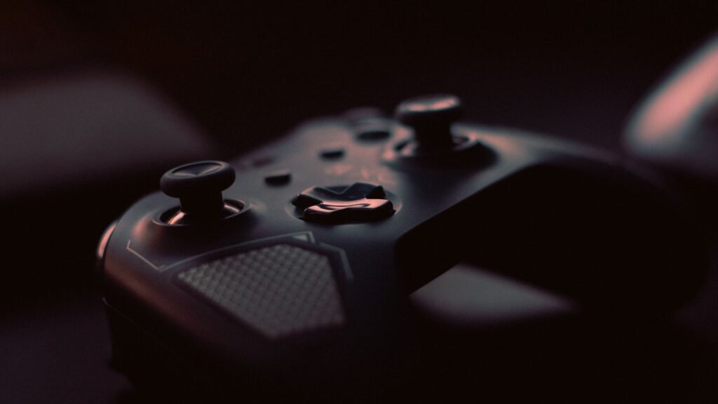 Video game controller on a dark surface representing console gaming