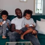Family playing a motion-controlled video game together in a living room