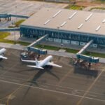Aerial view of an airport terminal with airplanes at the gates