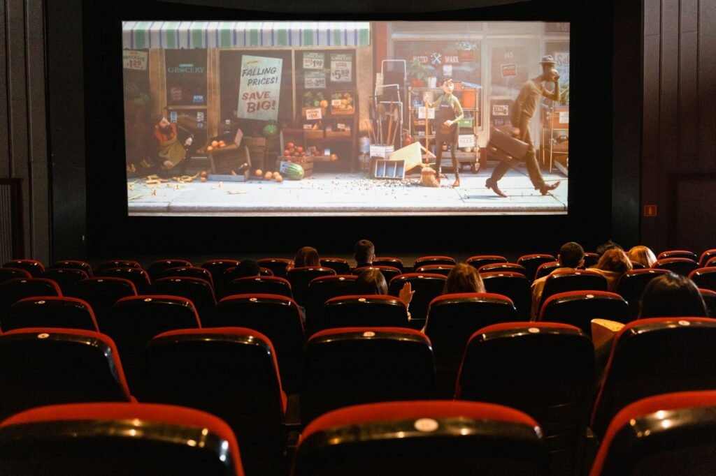 Rows of empty seats facing a large screen inside a movie theater
