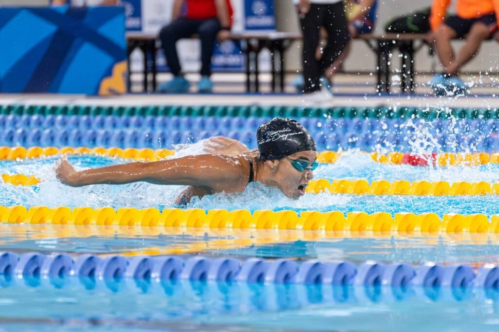Competitive swimmer racing through the water in an Olympic size pool