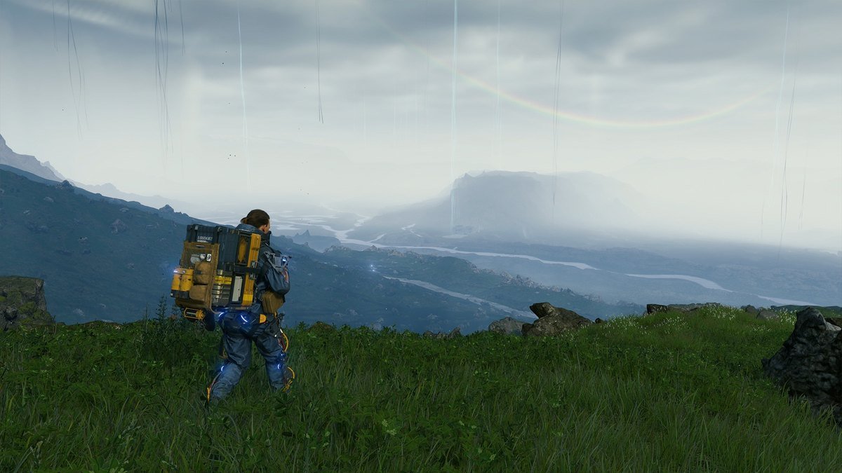Death Stranding Director's Cut on iPhone showing Sam Bridges looking over a green valley