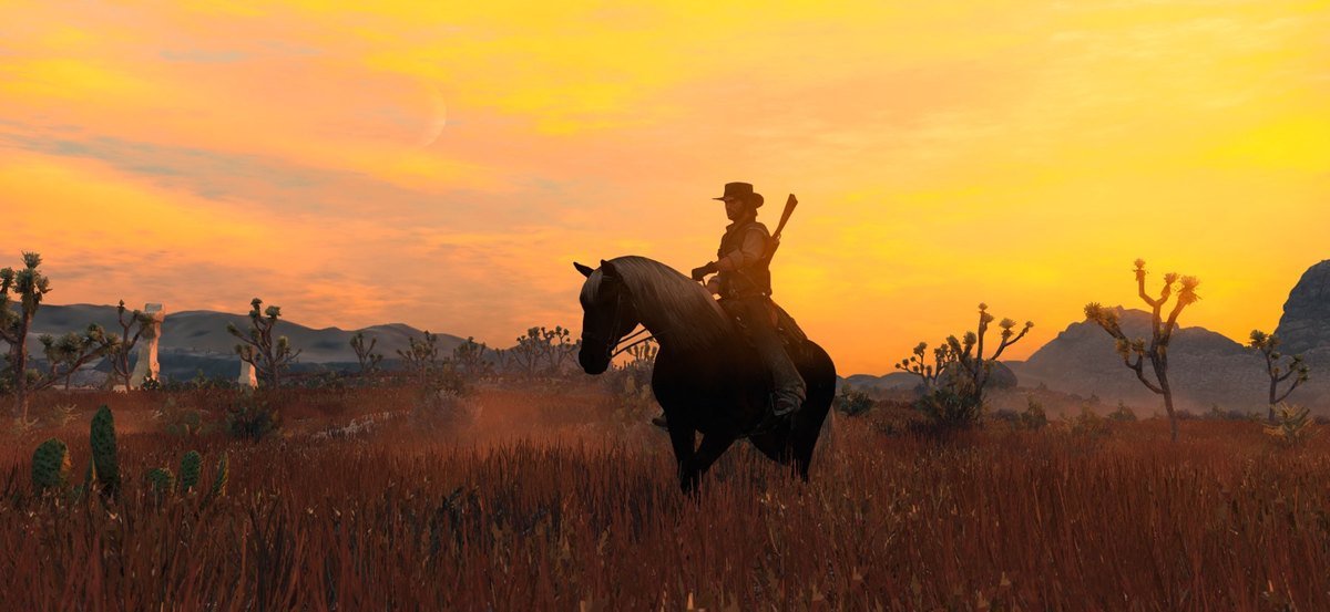 Red Dead Redemption on iPhone showing John Marston riding at sunset