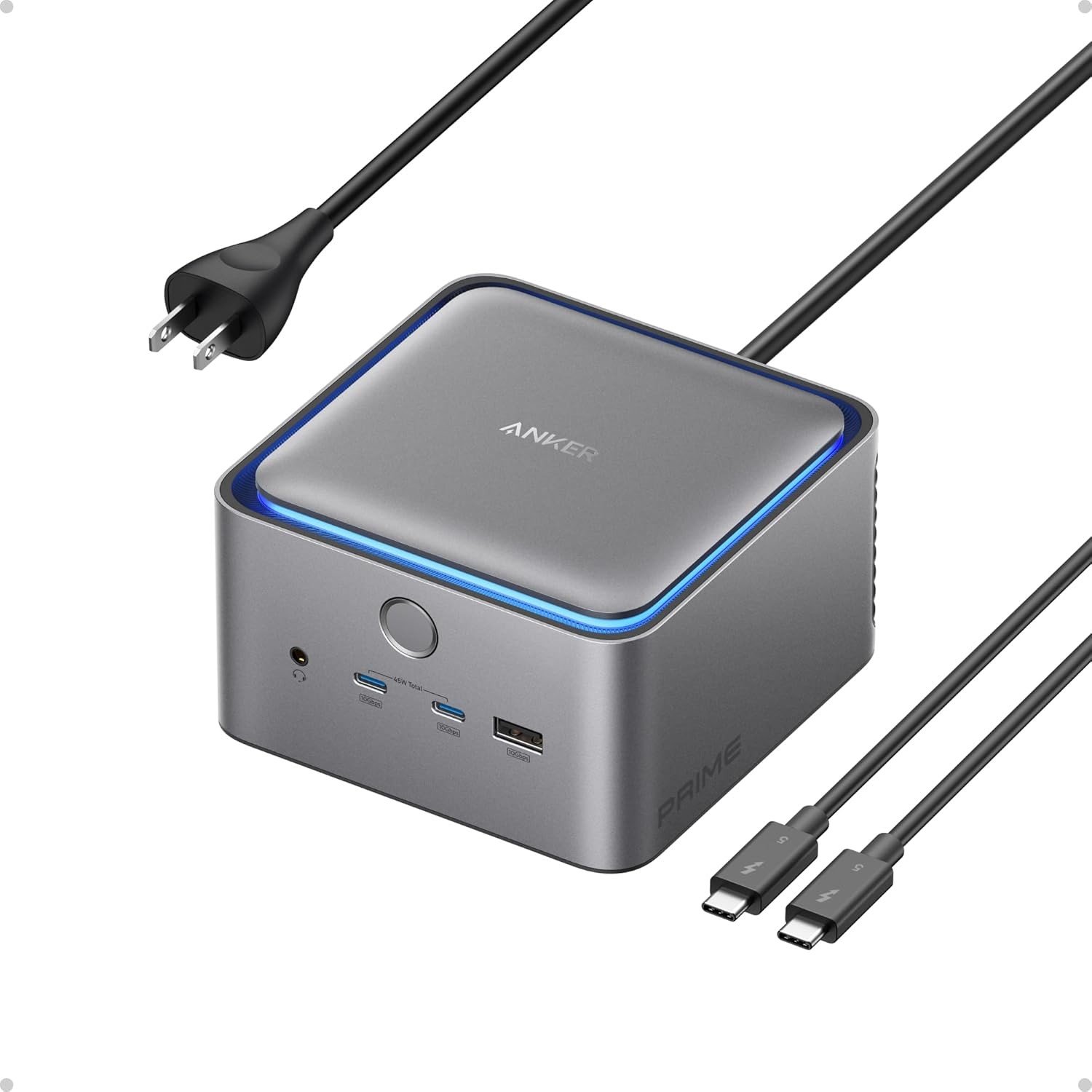 Anker Prime TB5 Docking Station, a compact grey cube with a lit ring, shown with its power and Thunderbolt cables