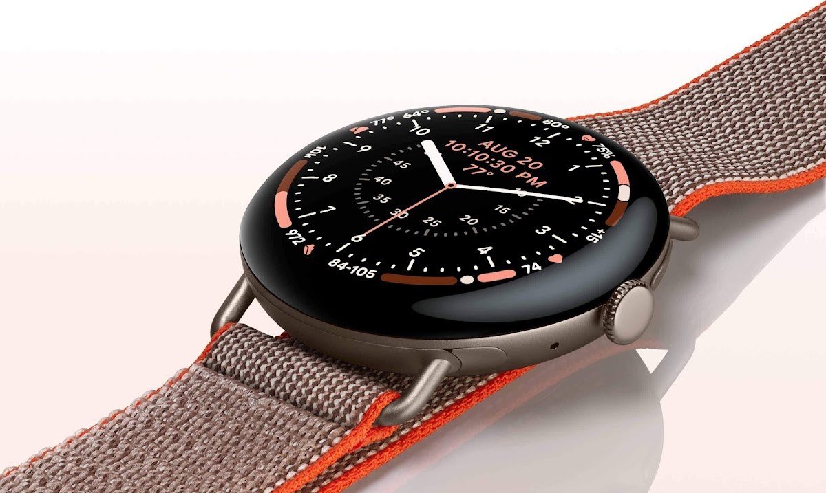 Google Pixel Watch 5 with an analog watch face and woven band