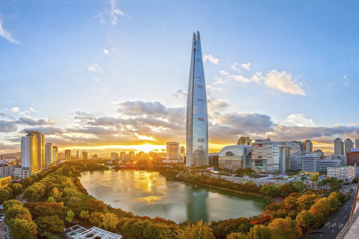 Lotte World Tower in Seoul at sunset beside Seokchon Lake