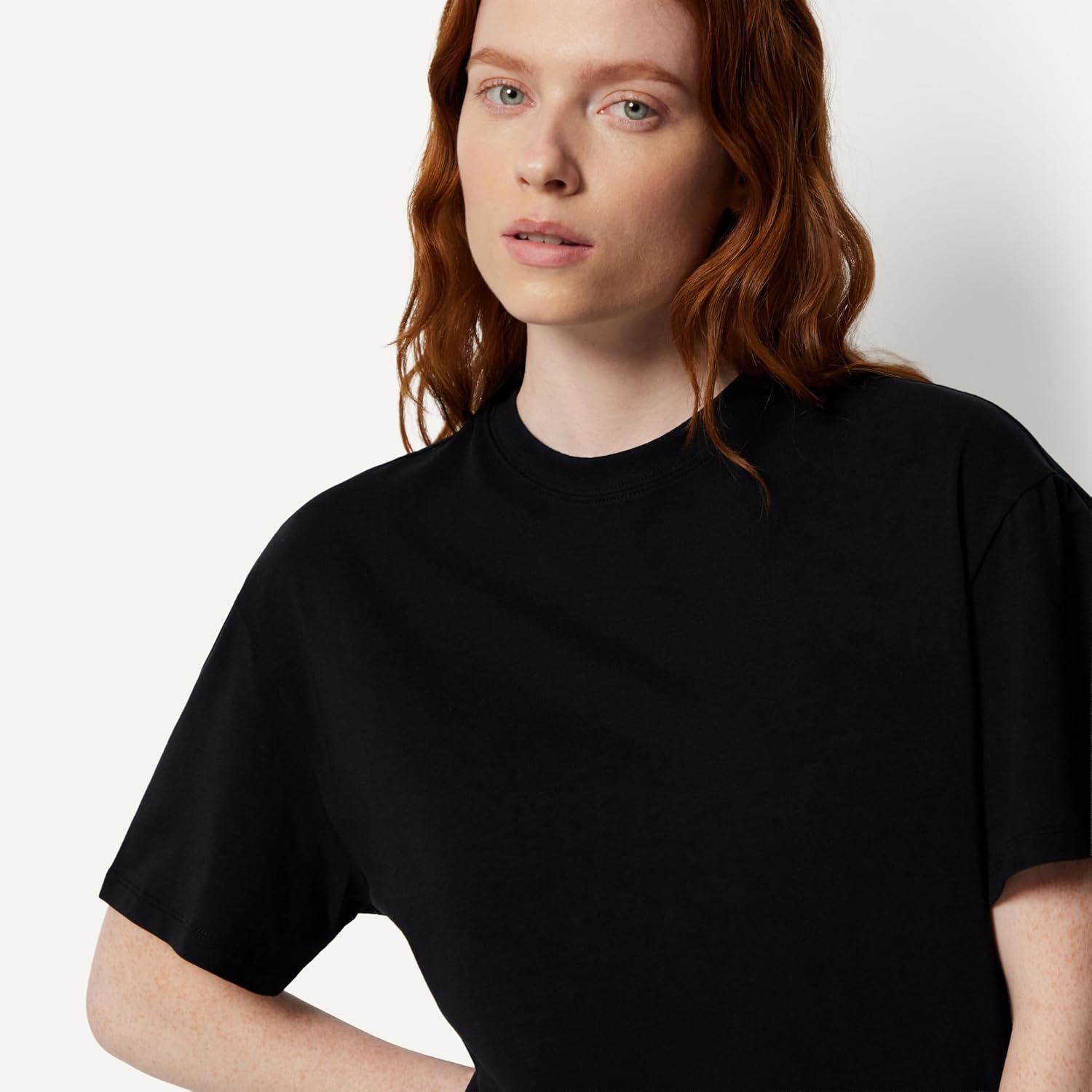 Woman in a black Amazon Essentials oversized-fit crewneck t-shirt with dropped shoulders