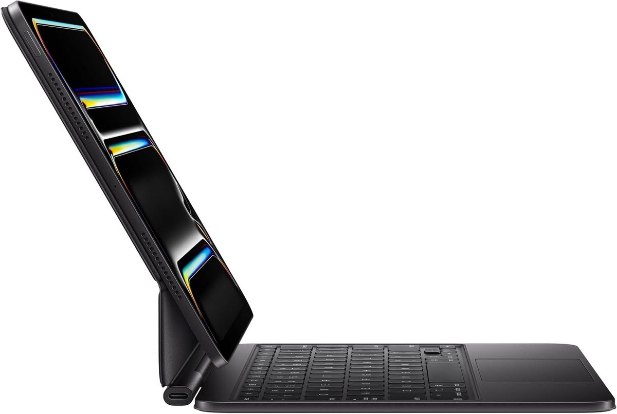 Apple Magic Keyboard seen from the side holding an 11-inch iPad Pro on its cantilever hinge