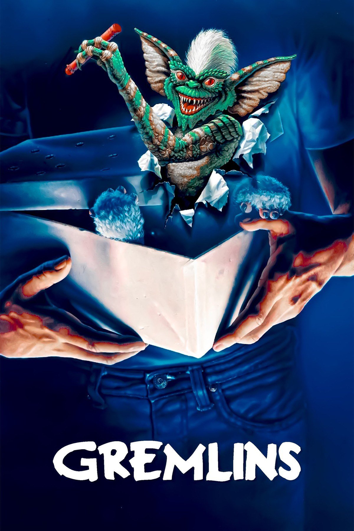 Gremlins poster with a green gremlin bursting out of a gift box