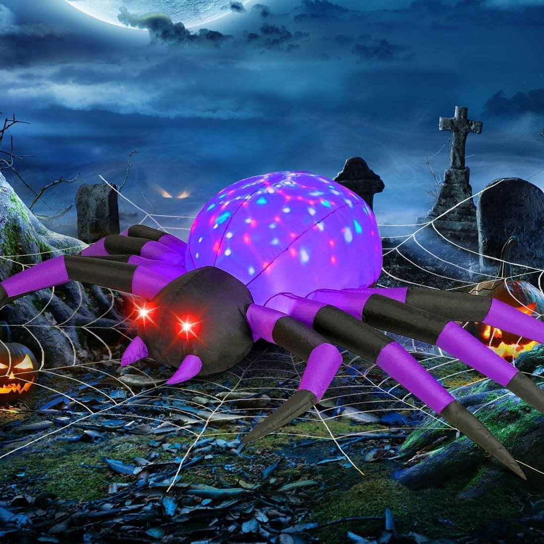 COMIN 9 ft purple and black spider inflatable with red eyes lit up in a yard at night
