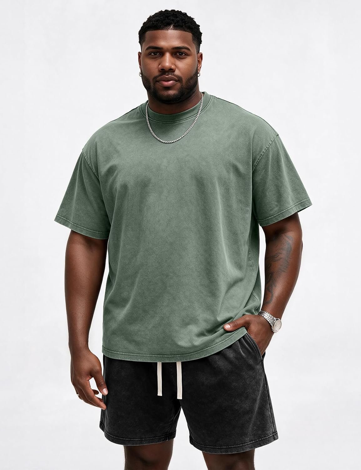 Man in a washed green Eisctnd big and tall t-shirt with a dropped shoulder seam
