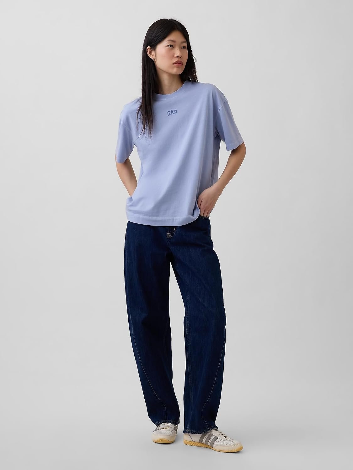 Woman wearing a pale blue GAP oversized vintage tee with wide leg jeans
