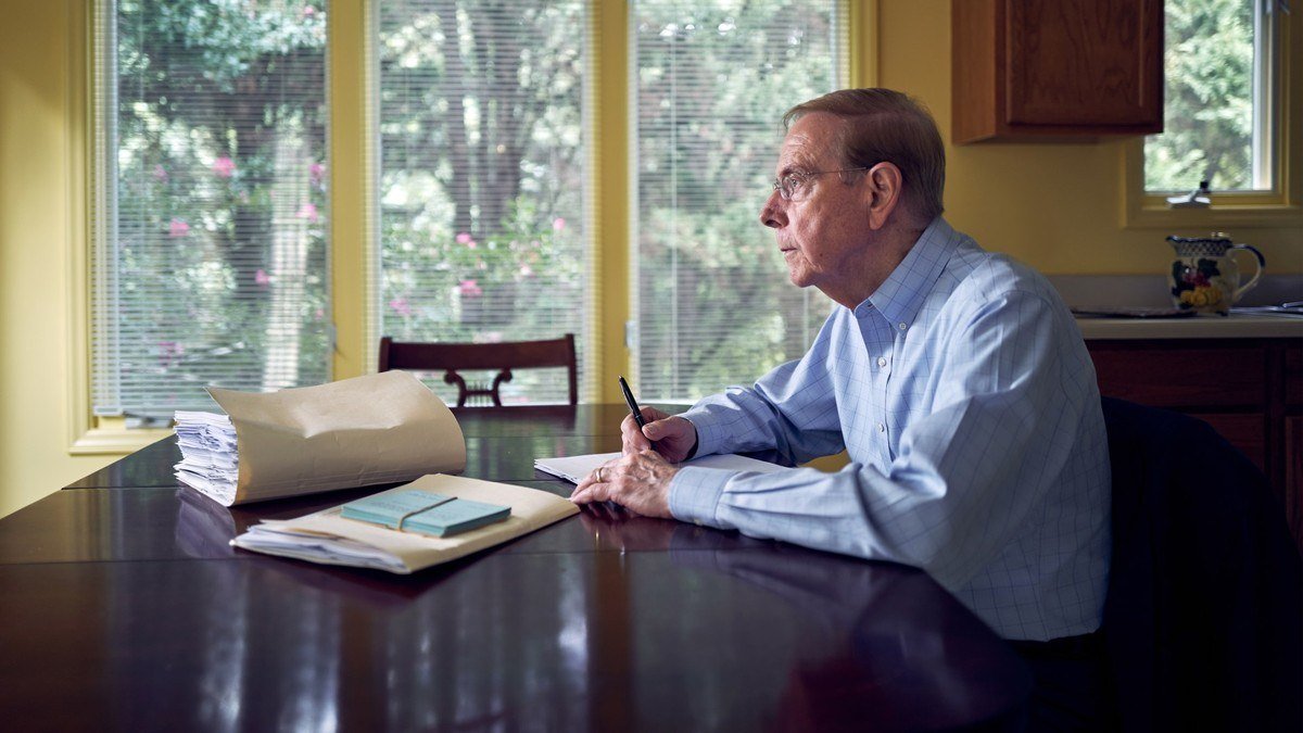 Gary Chapman writing at a table in his Winston-Salem home