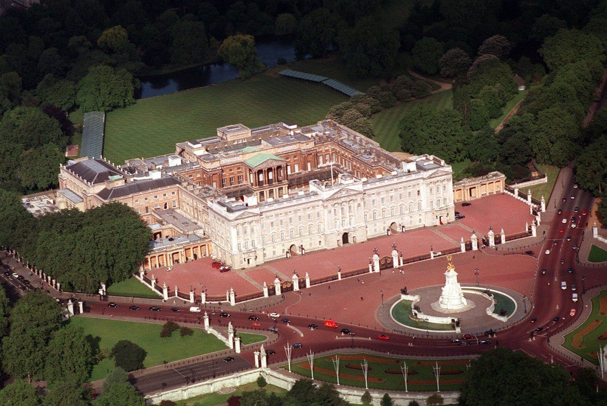 Aerial view of Buckingham Palace, its red forecourt and the Queen Victoria Memorial