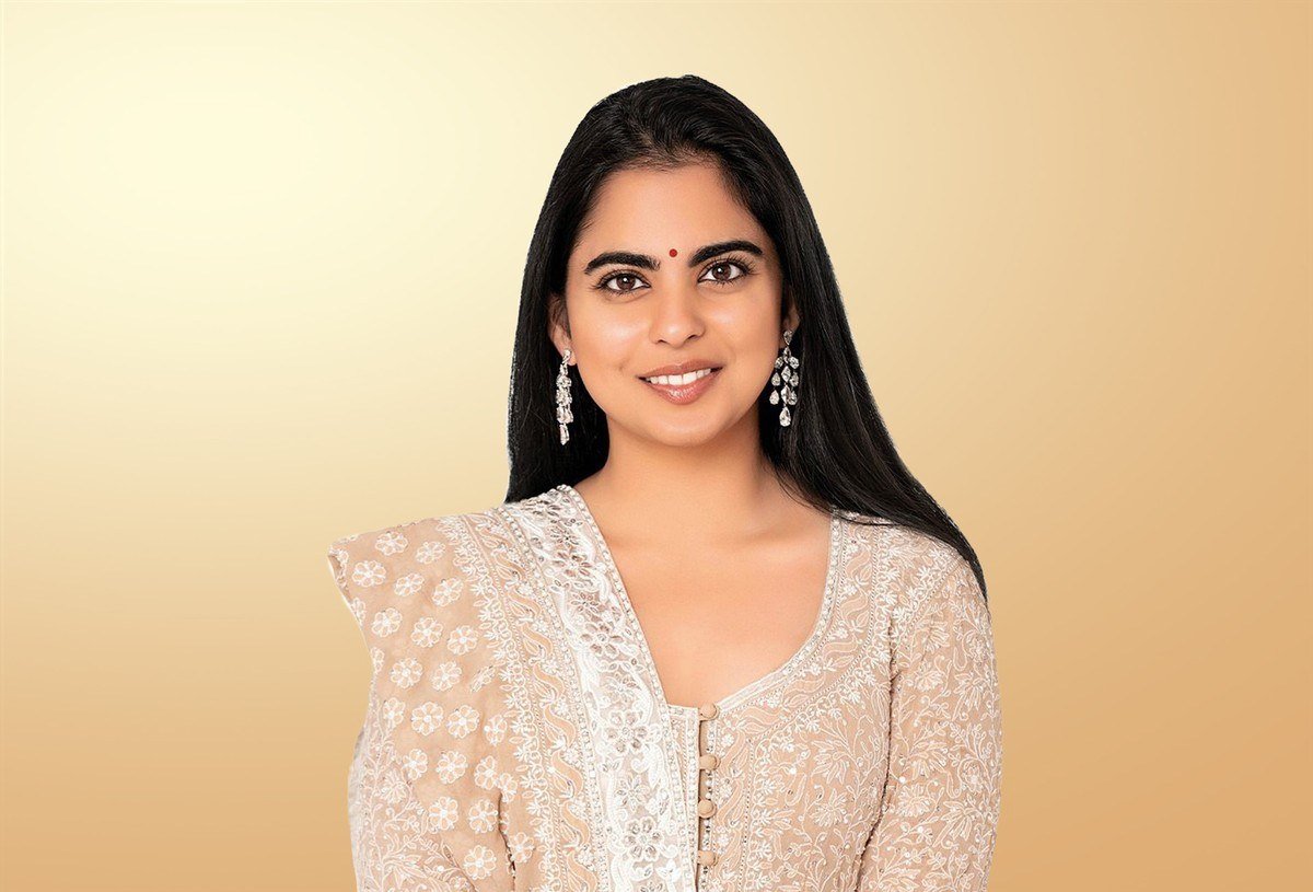 Portrait of Isha Ambani against a warm gold background