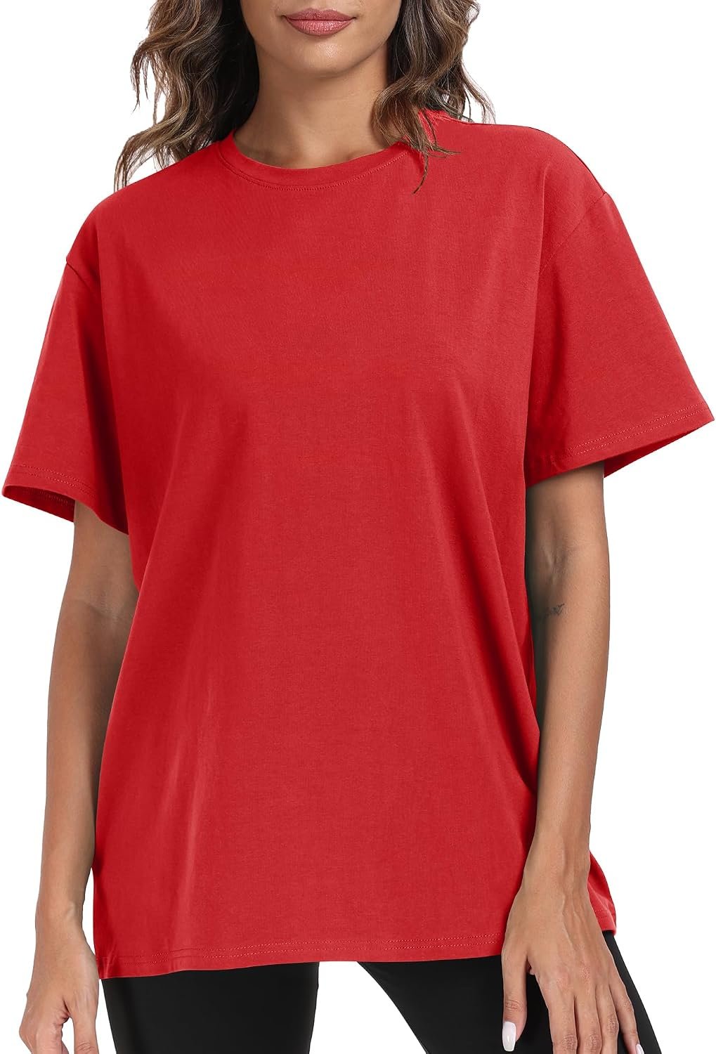 Woman in a red PRIMODA oversized loose fit t-shirt worn over black leggings