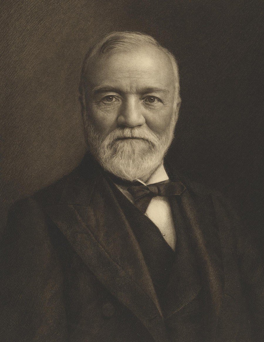 Portrait photograph of Andrew Carnegie with a white beard and dark jacket